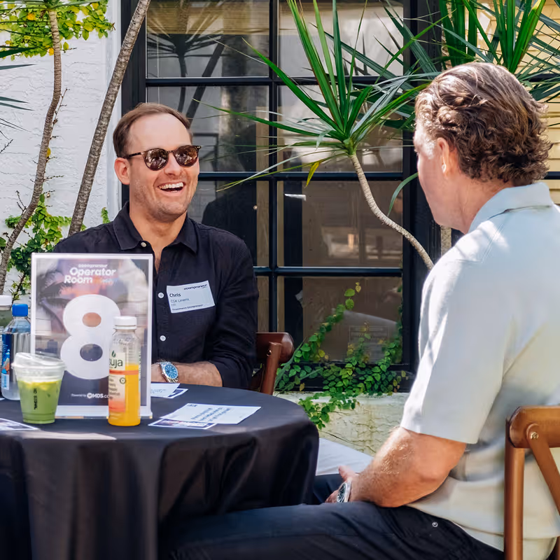 Two founders in conversation at an outdoor Ecompreneur event