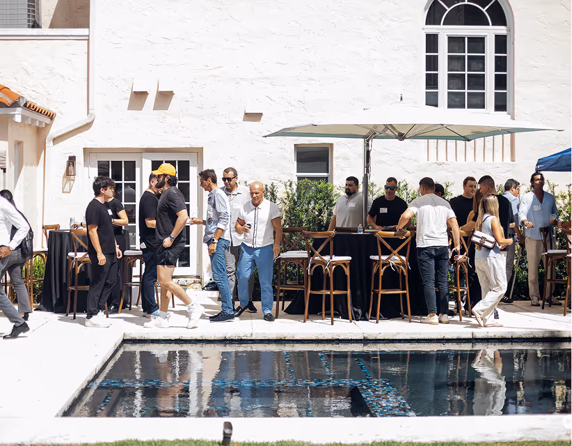Founders mingling at an outdoor industry event patio