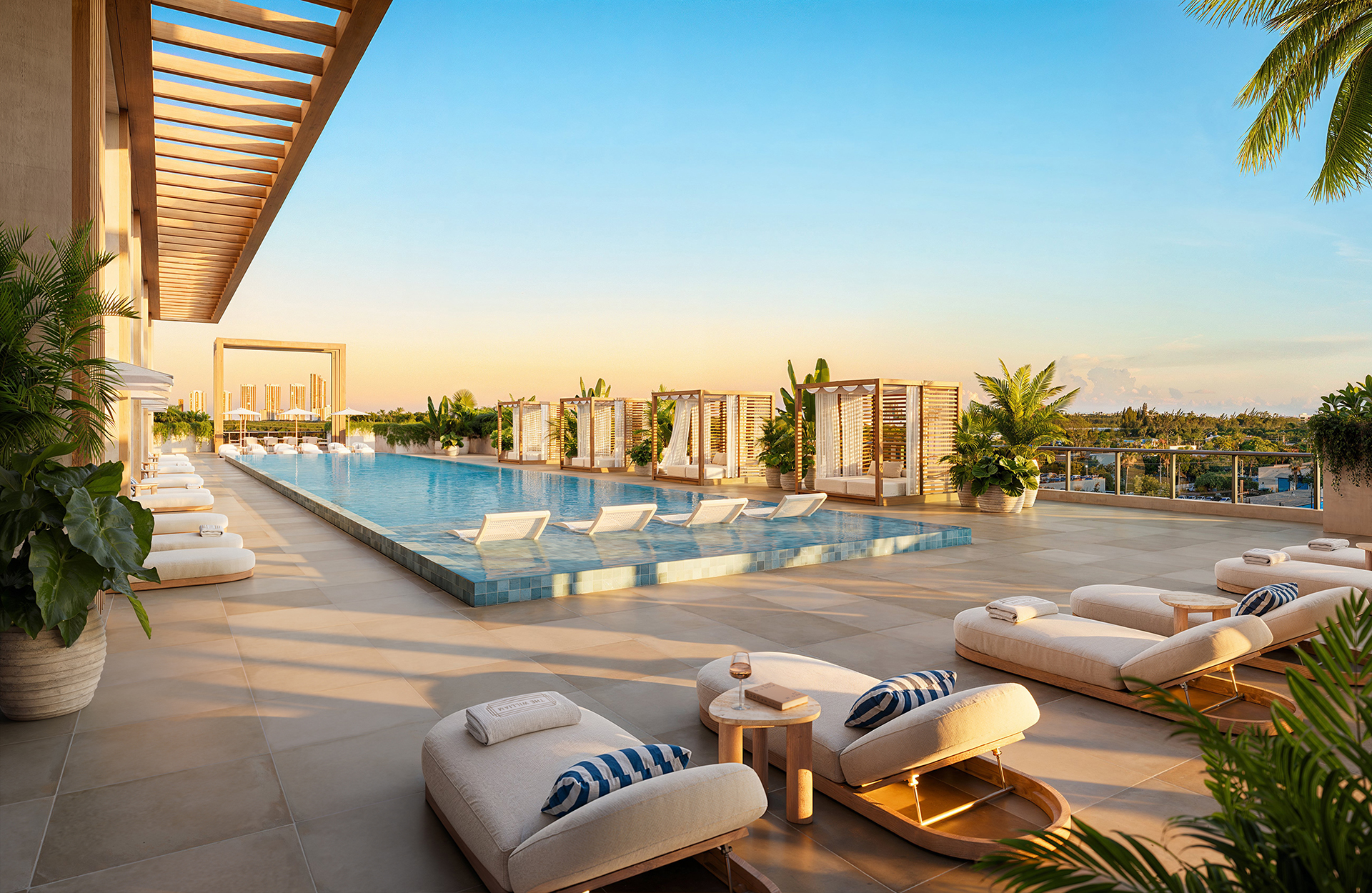 Resort-style pool deck at The William Residences with landscaped seating and outdoor bar in North Miami Beach