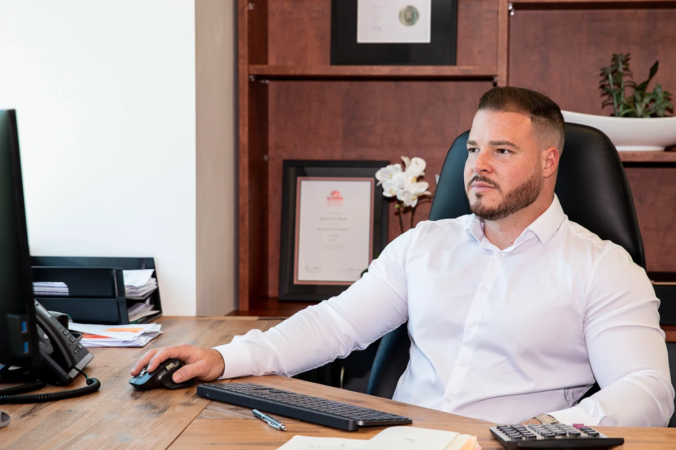 Accountant working at his desk in the A-Team Tax office, Varsity Lakes