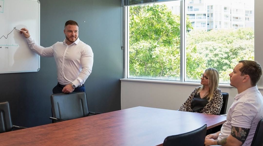A-Team Tax accountant walking clients through a plan in the meeting room