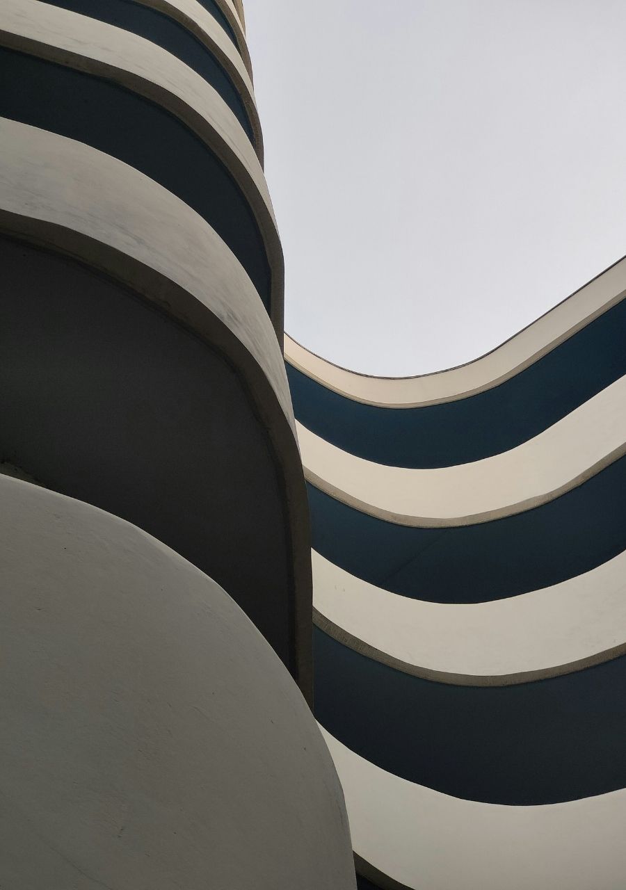 Curved building facade in navy and cream