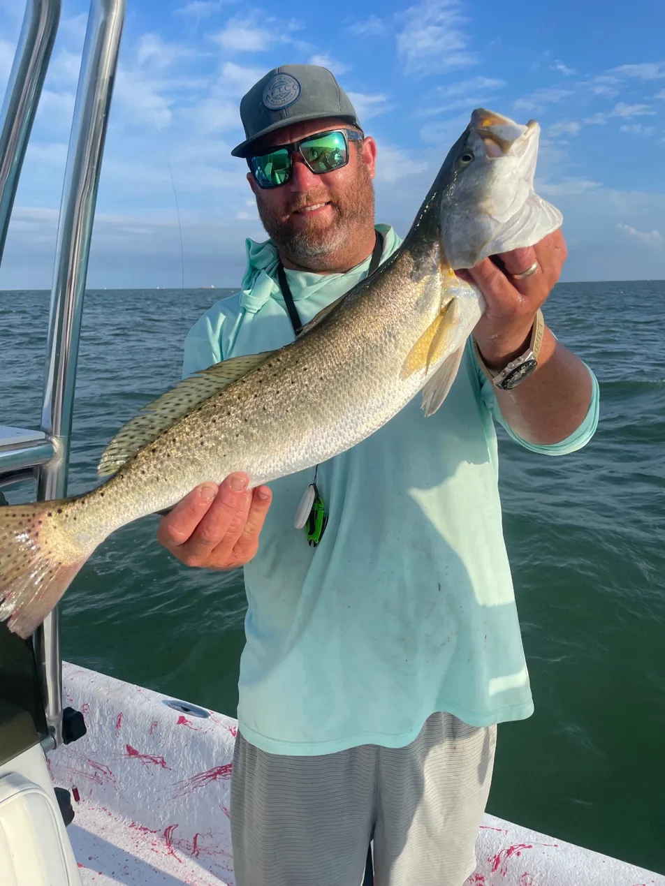 captain corey bickford holding out a massive fish while fishing