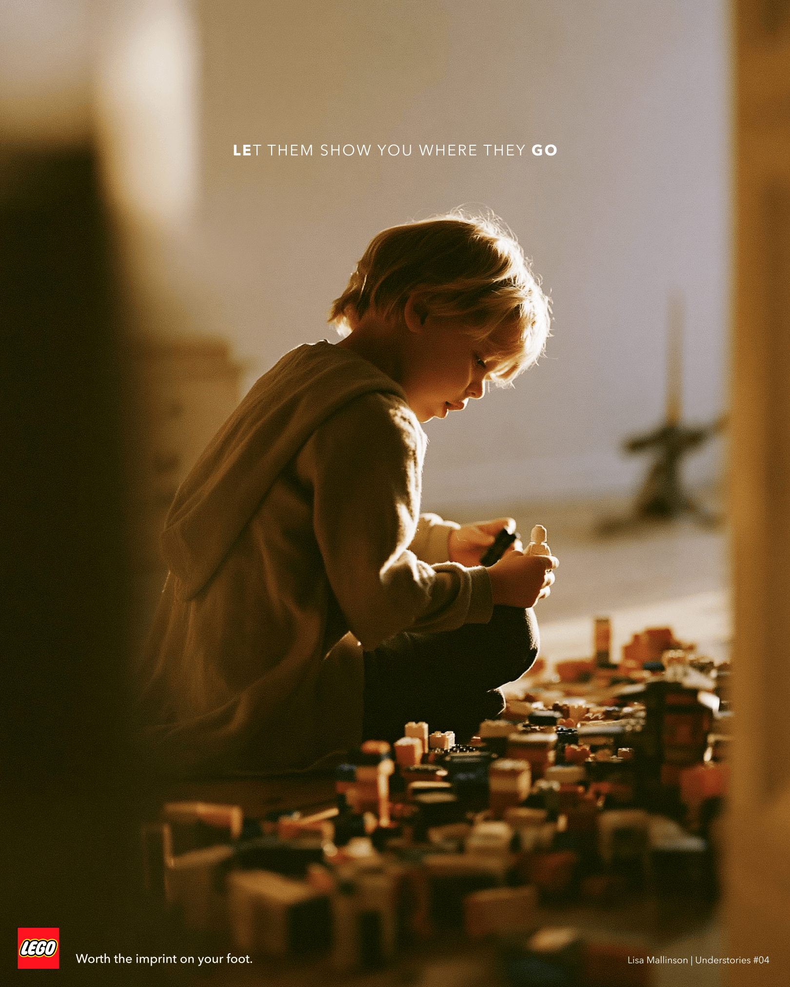 LEGO concept poster showing a child sitting on the floor, absorbed in building with LEGO bricks scattered around them in warm afternoon light. Text reads: “Let them show you where they go” and “Worth the imprint on your foot.”