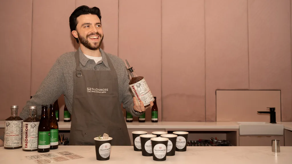 Lewis Kennedy of Talonmore holding a bottle of Talonmore 0.0% botanical spirit at an Edinburgh tasting event
