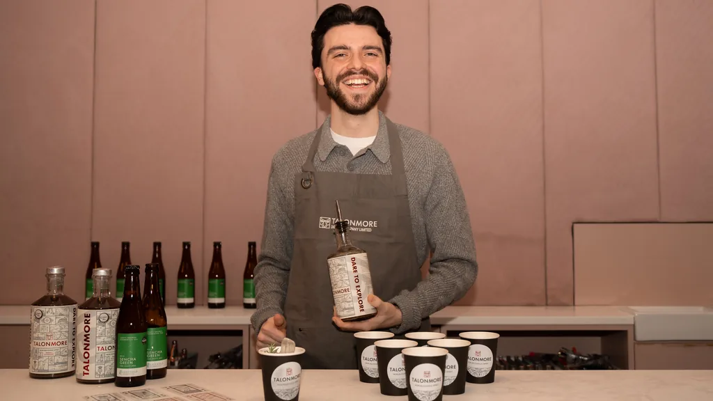 Lewis Kennedy behind the Talonmore bar with bottles, Sencha Green and tasting cups
