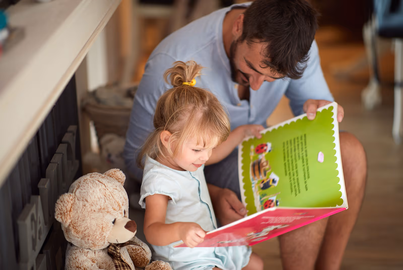 Father and daughter reading book