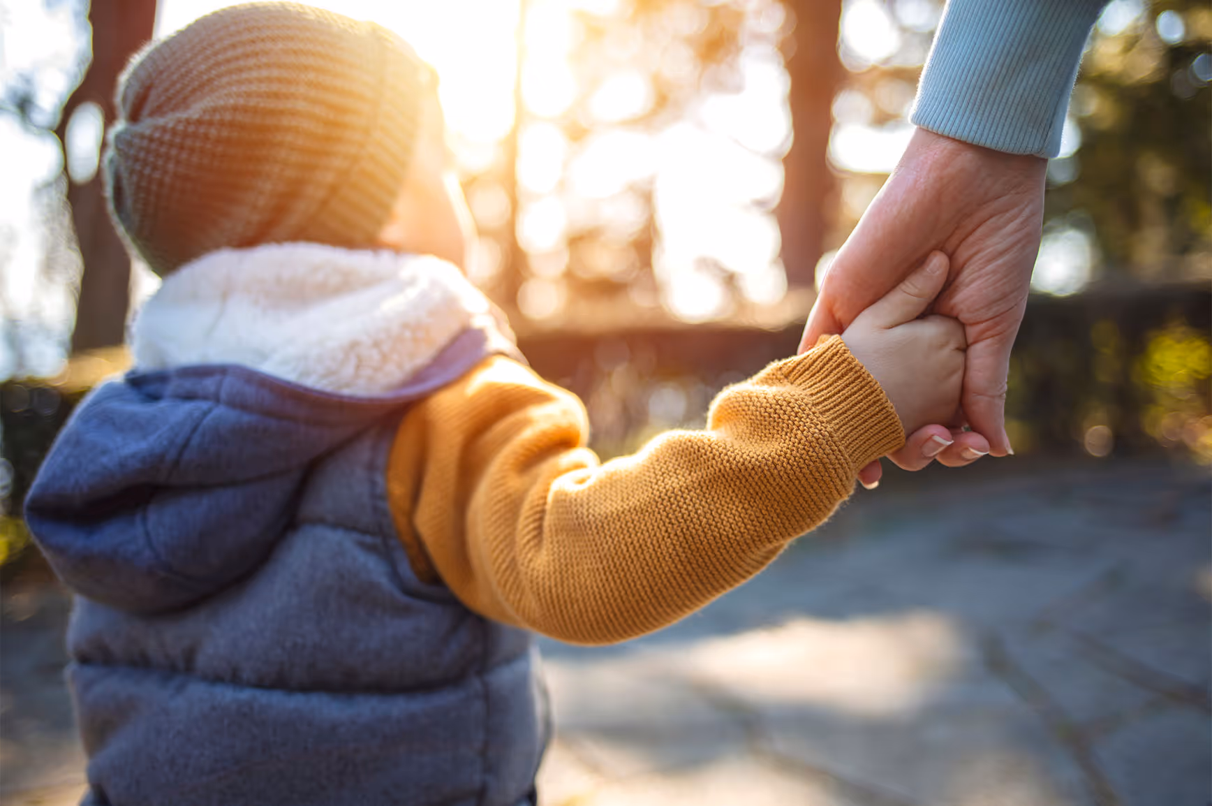 Father and son holding hands walking