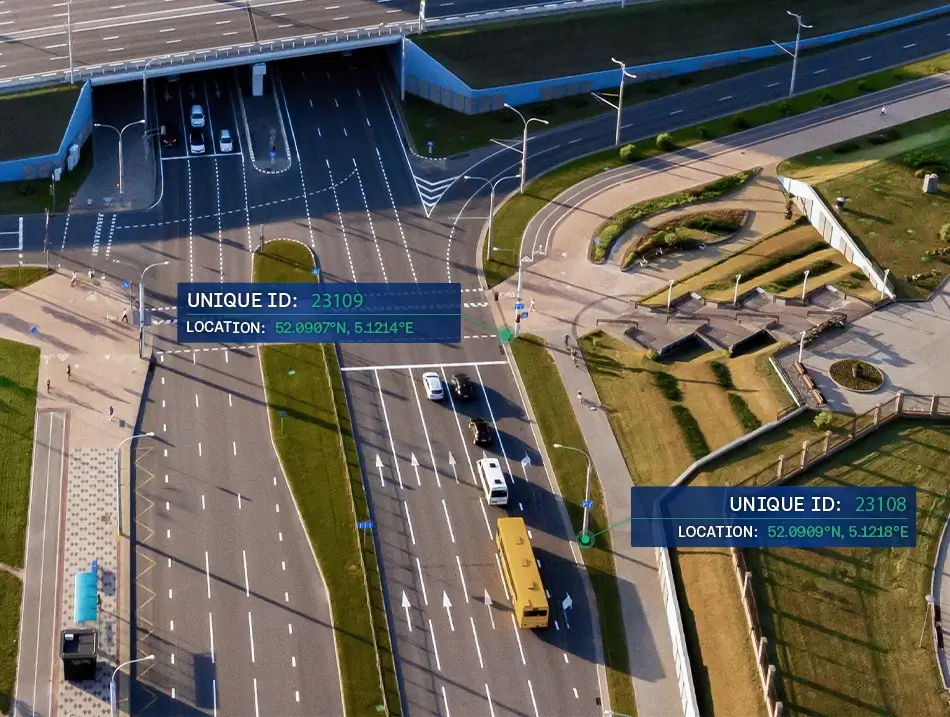 Aerial view of a road intersection with digital location markers, unique IDs, and coordinate data overlays