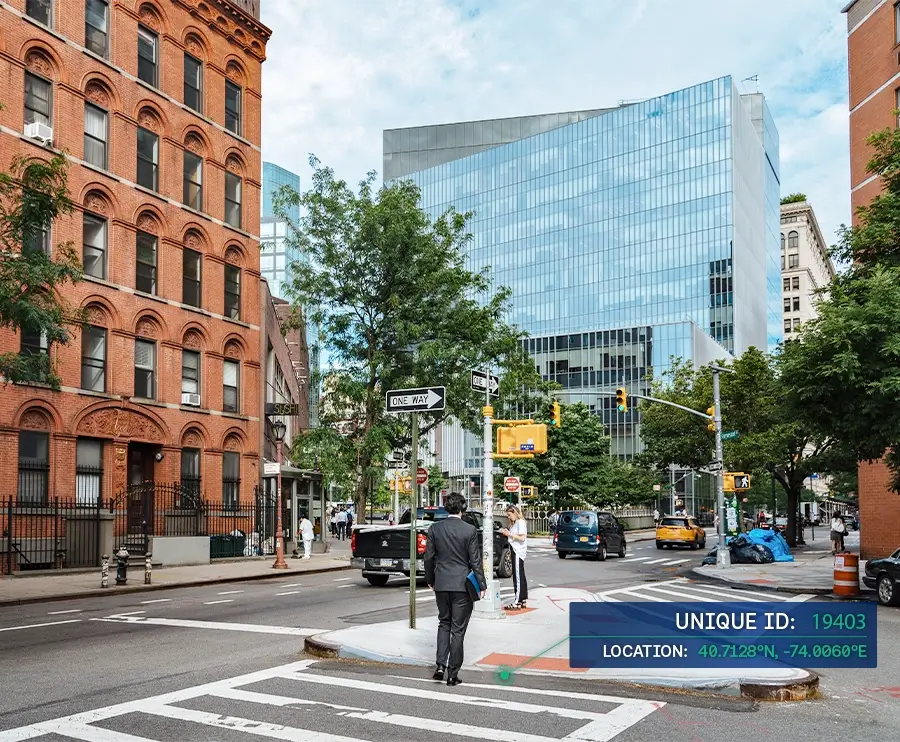 New York street corner with brick and glass buildings, pedestrians, traffic, and a digital overlay showing a unique ID and location coordinates