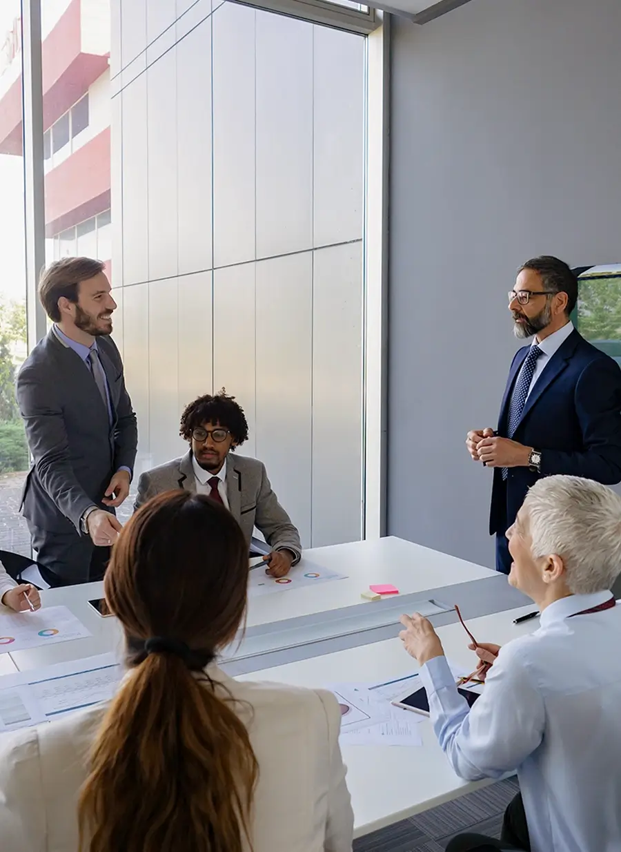 Business professionals in a modern meeting room discussing documents during a team collaboration session