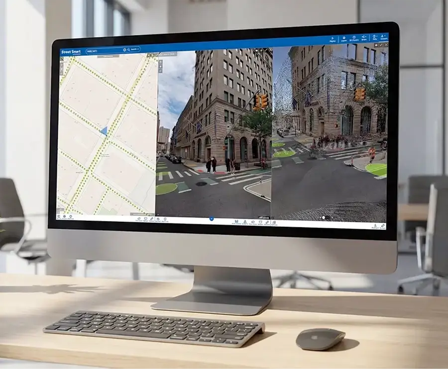 Desktop monitor in an office displaying the Street Smart interface with map, street-level imagery, and LiDAR point cloud views