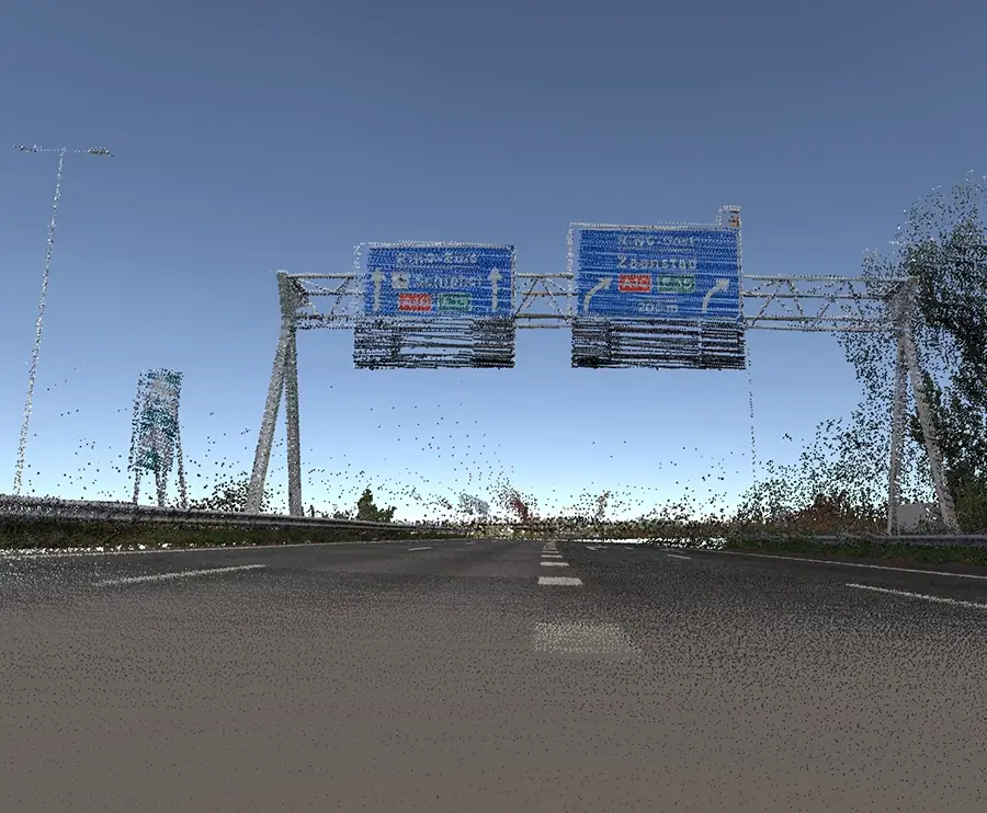 LiDAR point cloud view of a highway with overhead direction signs, lane markings, and roadside trees