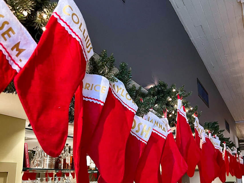 Christmas stocking hung in a row above the bar
