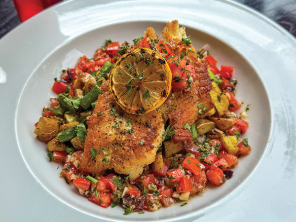 A plate of pan-seared grouper of vegetables