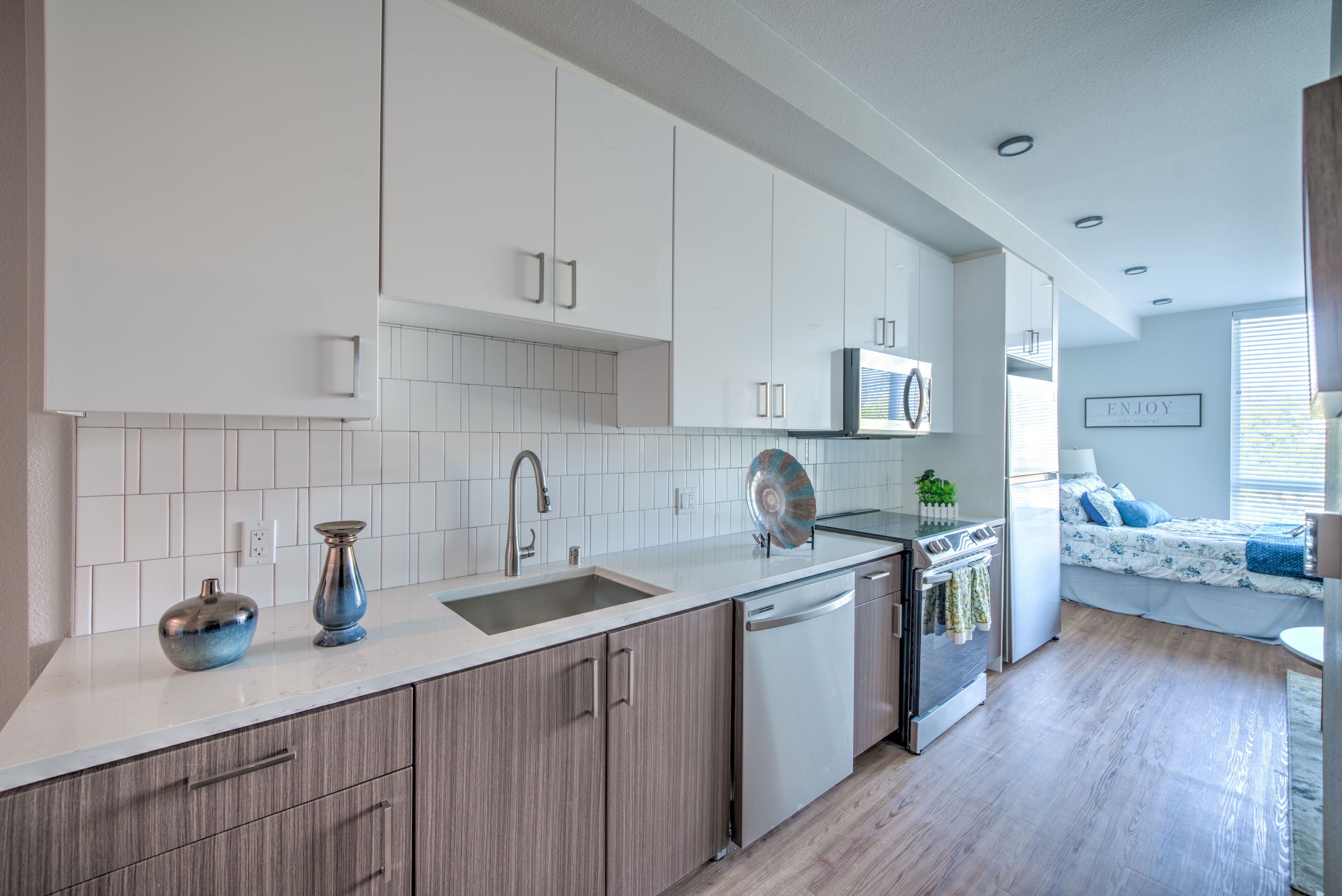 Studio kitchen with white and brown cabinets