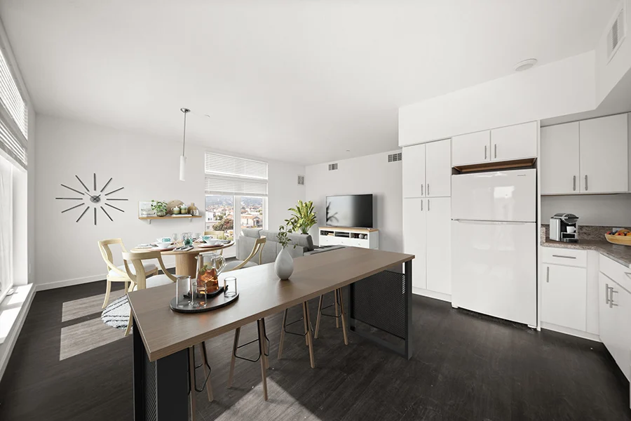 Virtually staged kitchen dining area featuring table, chairs and kitchen with white cabinets and appliances