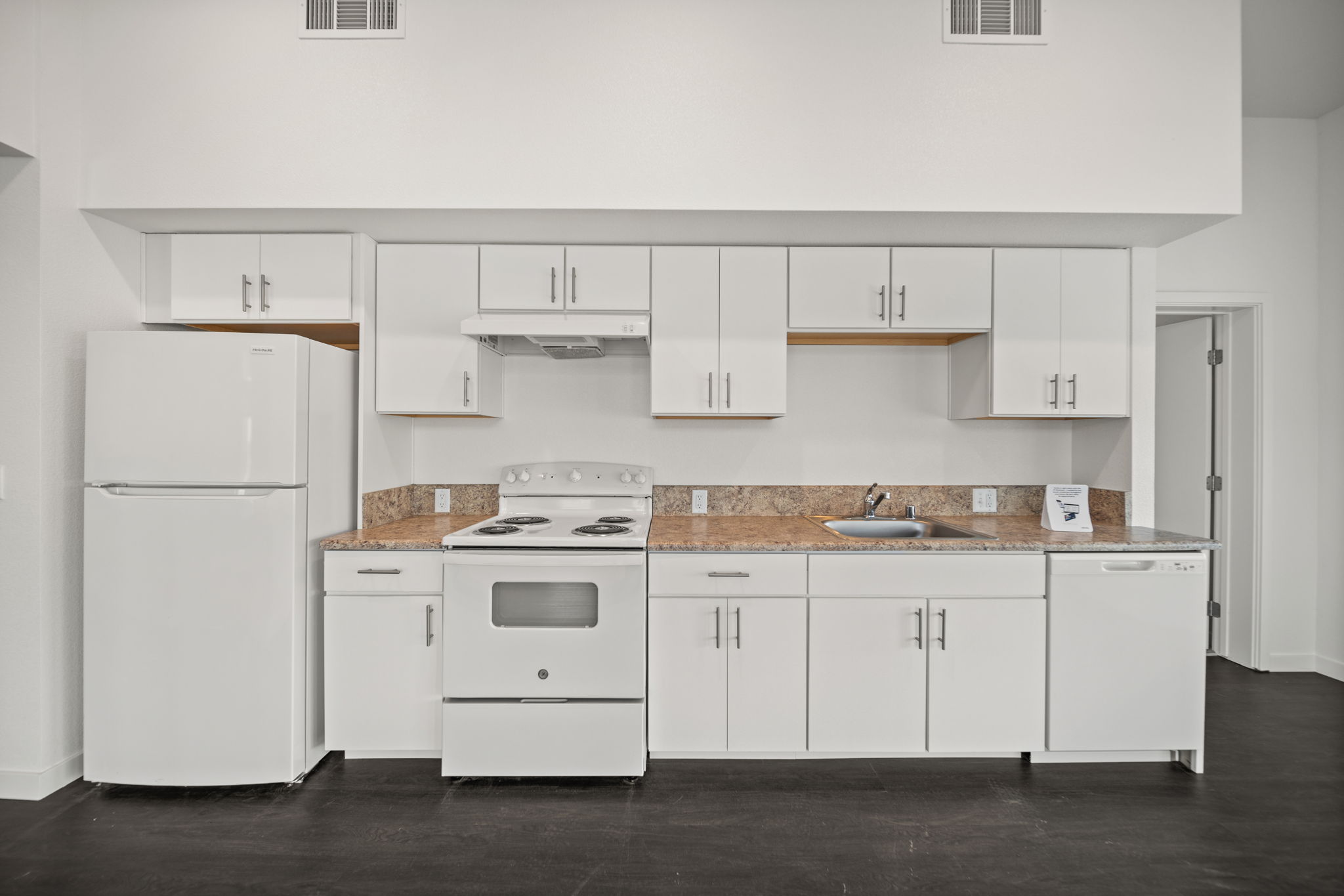 Kitchen with white cabinets and white appliances