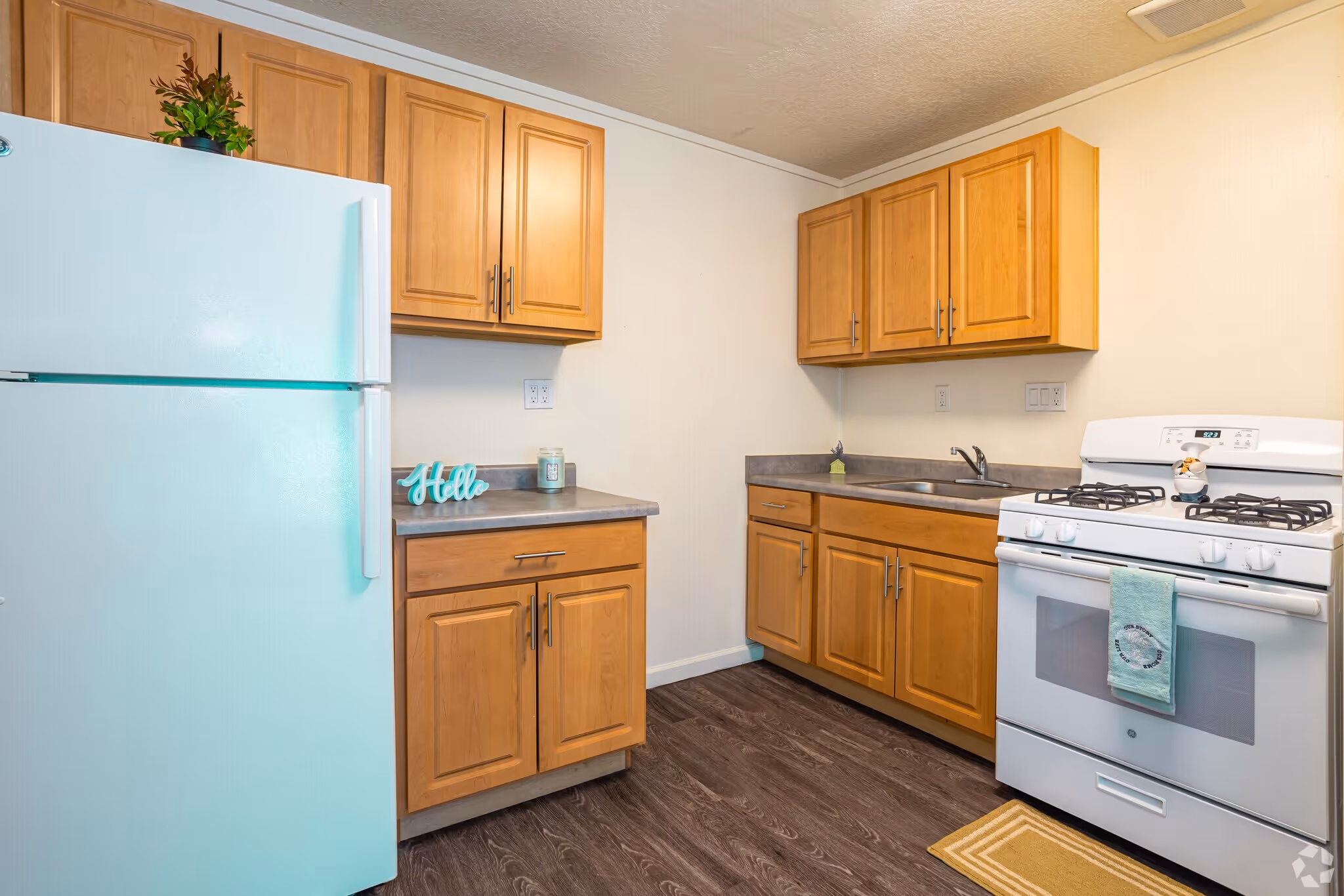 Kitchen with brown cabinets and white appliances