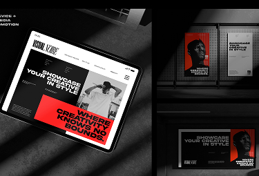Digital workspace featuring a website on a tablet displaying creative agency branding with bold red and black design elements and two framed posters on the wall with similar style and messaging.
