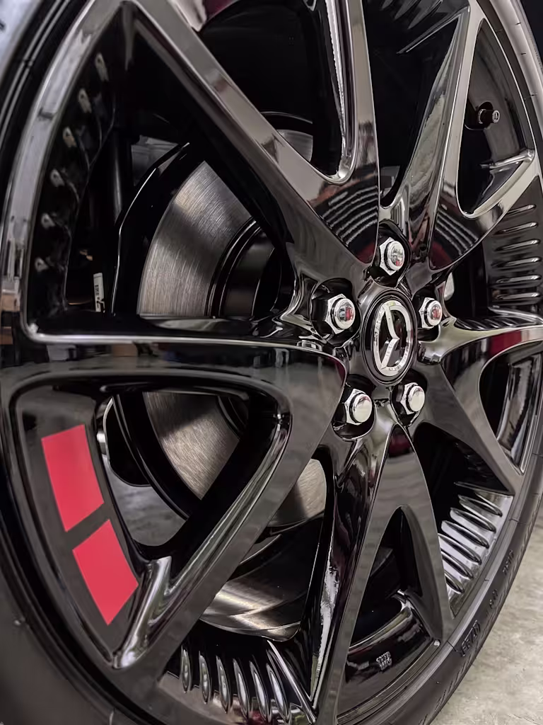 Badge and alloy wheel detail on the Mazda 2 Hybrid Homura Urban Edition