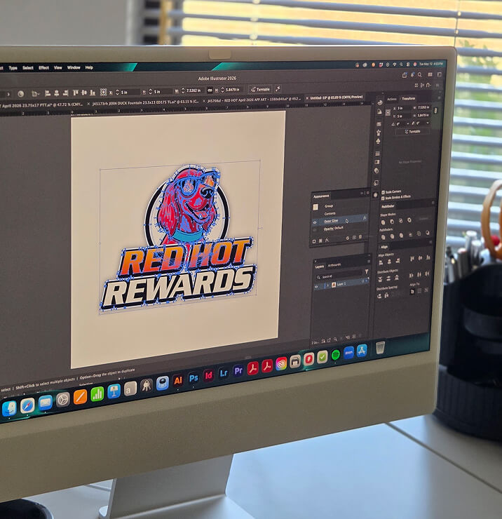 A Red Hot Rewards mascot logo being illustrated on-screen in Adobe Illustrator