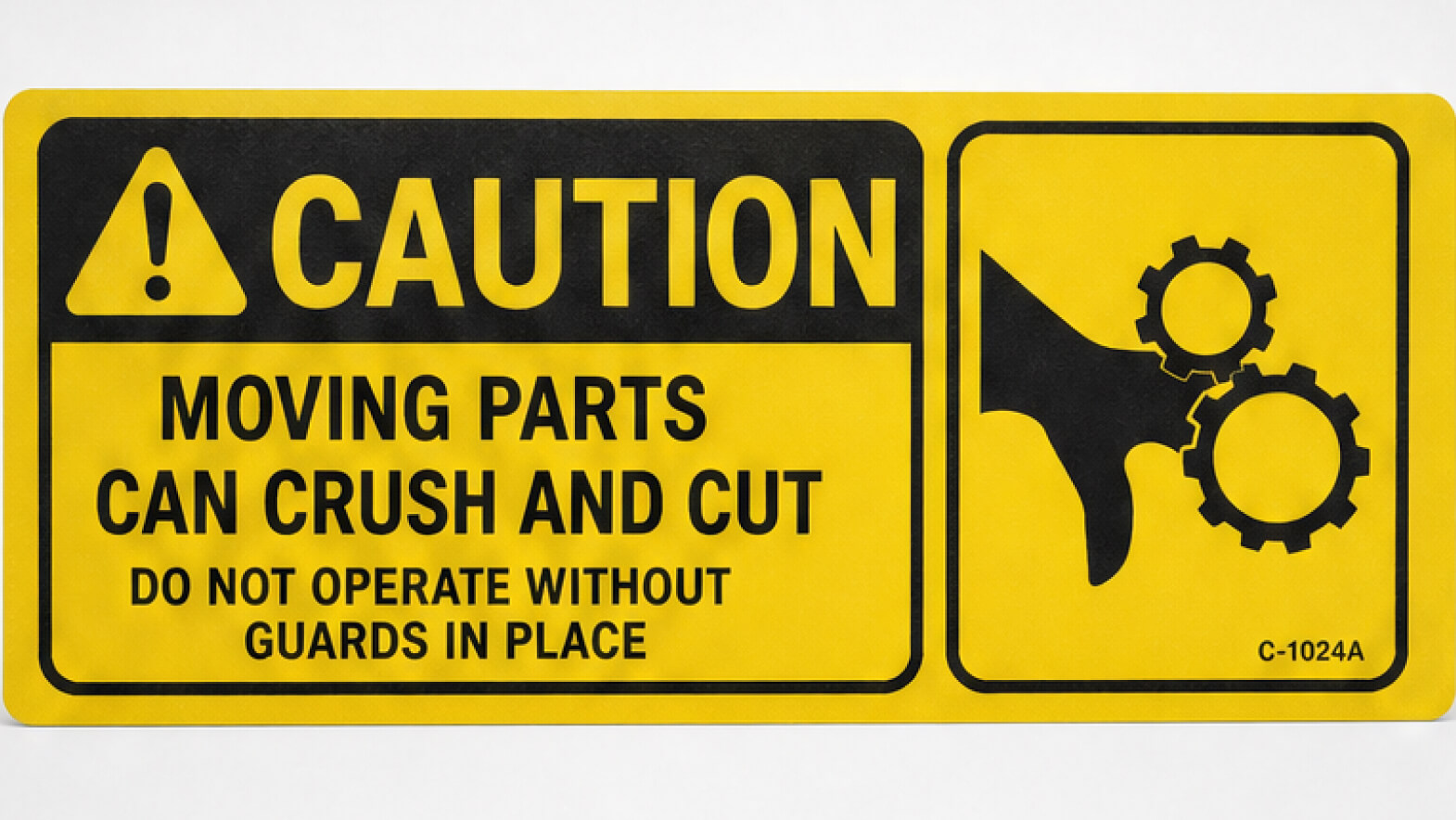 A yellow 'Caution - Moving Parts Can Crush and Cut' industrial safety label