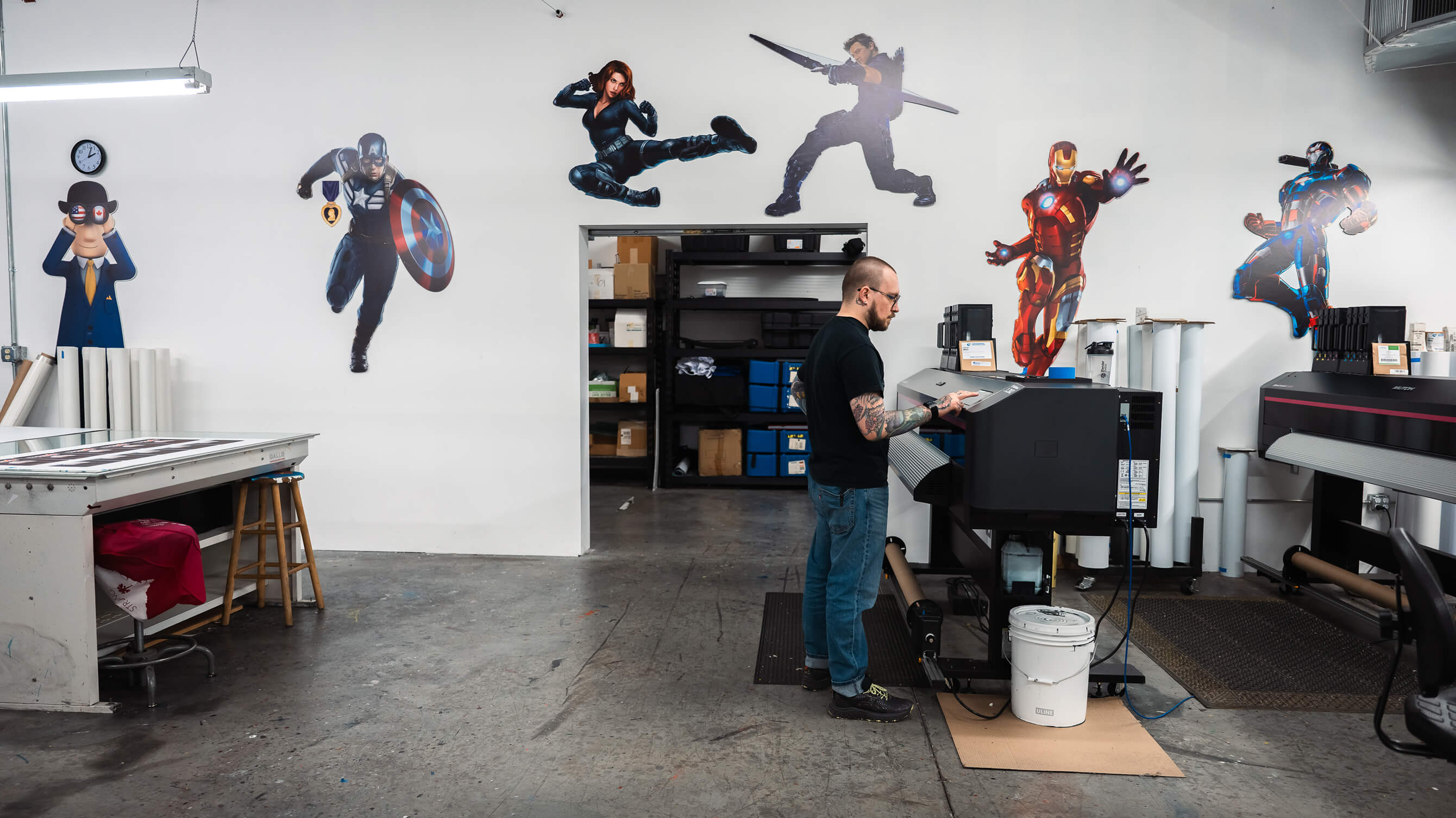 Custom die-cut Marvel character standees displayed in the TEC Graphics print shop