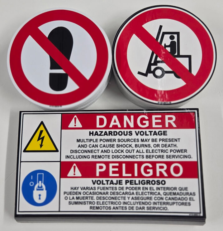 Screen-printed prohibition decals and a bilingual Danger hazardous-voltage label