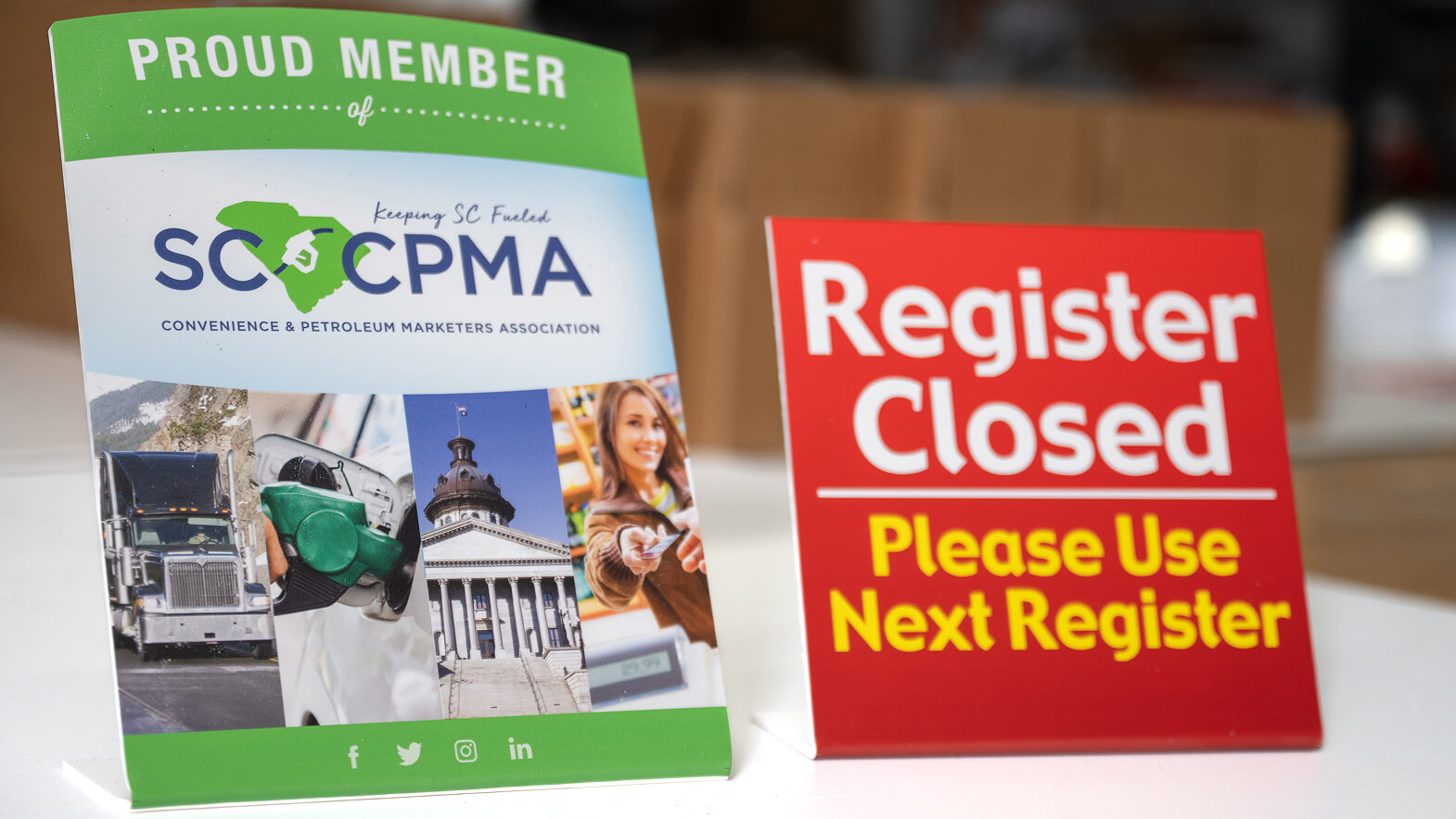 A printed SCPMA member sign and a red Register Closed counter sign