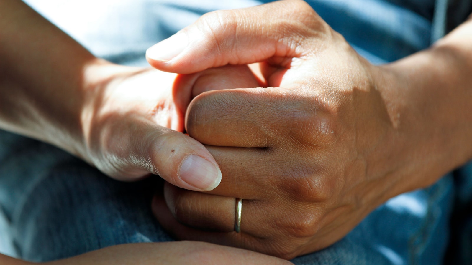 Two people's hands resting together
