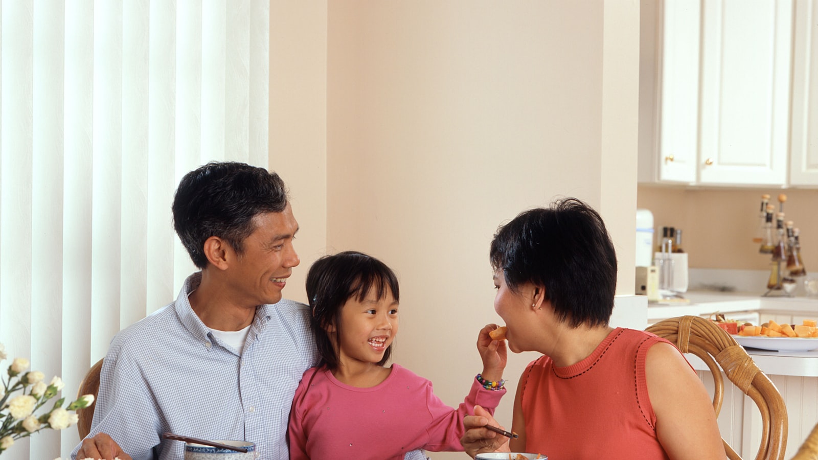 A family sharing a meal at the kitchen table