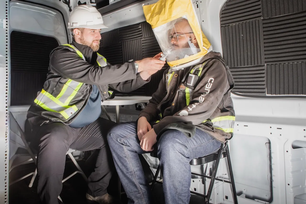 Clear Work technician performing a respirator fit test inside the mobile unit
