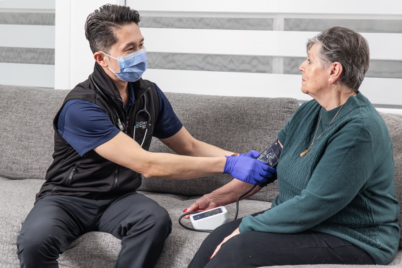Clear Home nurse checking a senior client's blood pressure during an in-home wellness check