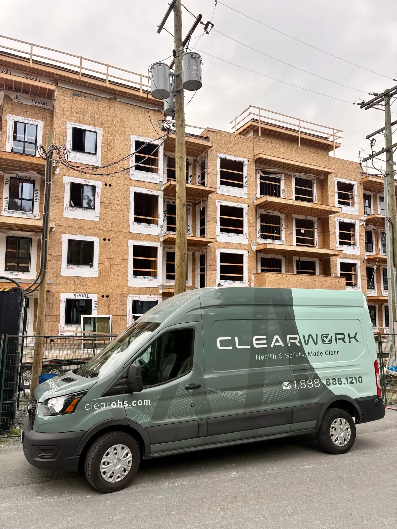 Clear Work mobile hearing testing van beside a building under construction