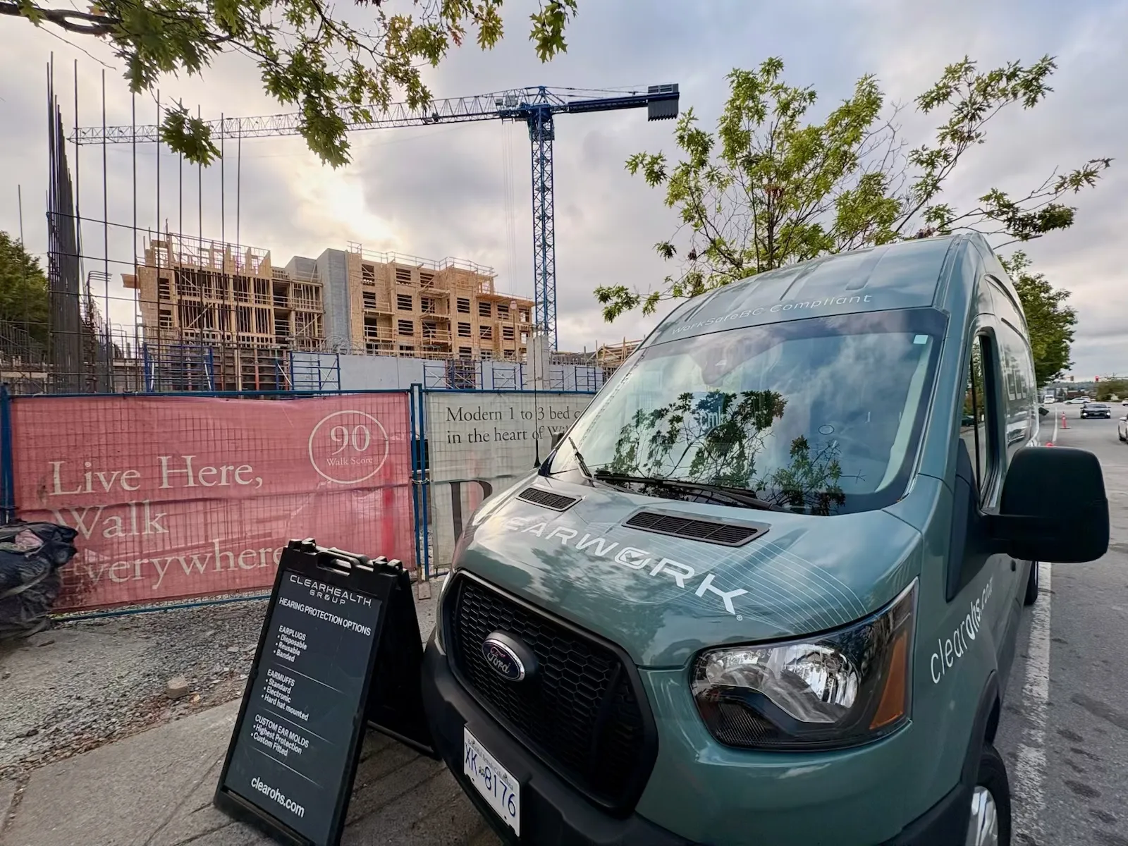 Clear Work van and sign set up at a high-rise construction site