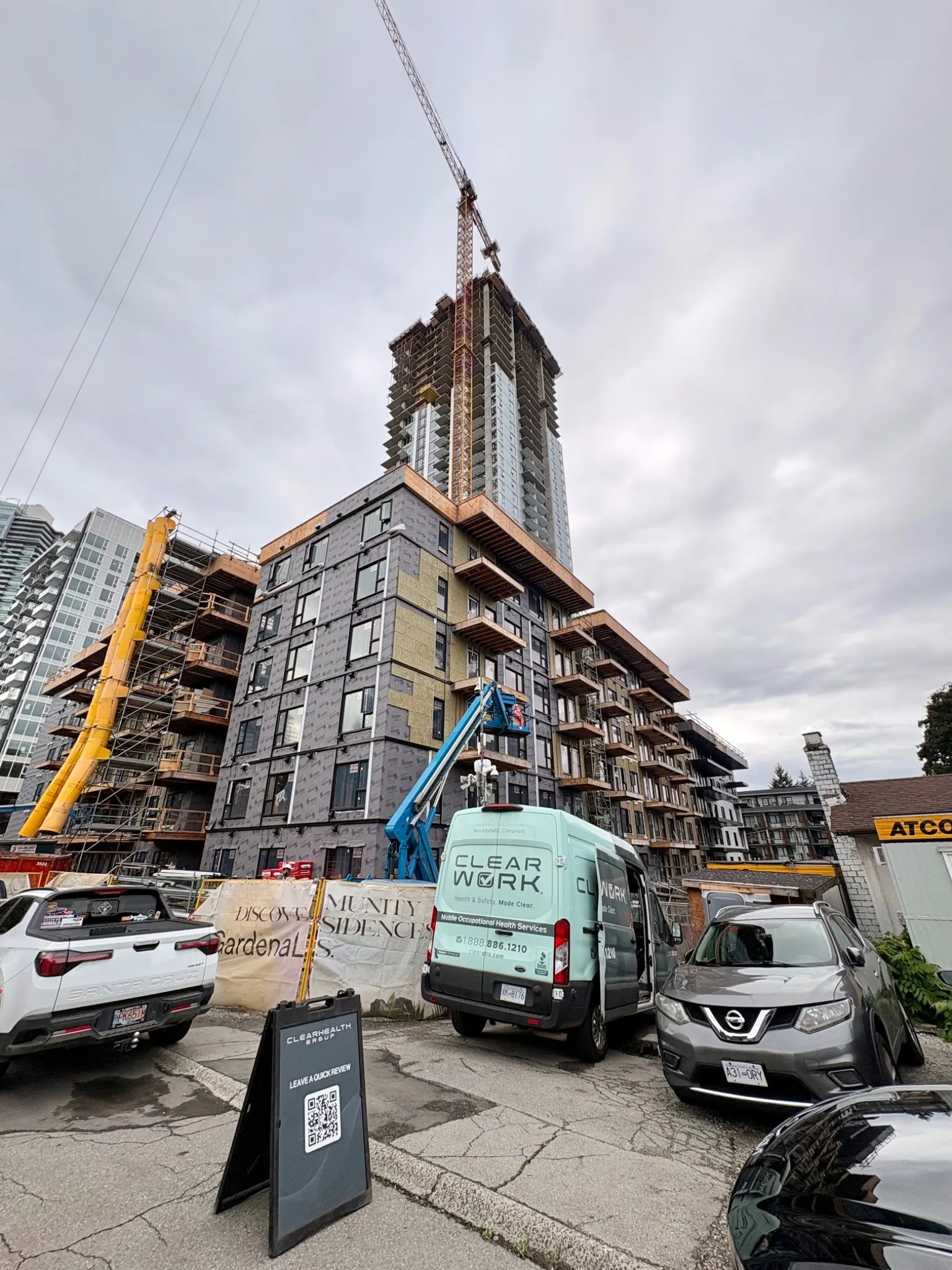 Clear Work van at a high-rise construction site with a tower crane in Vancouver
