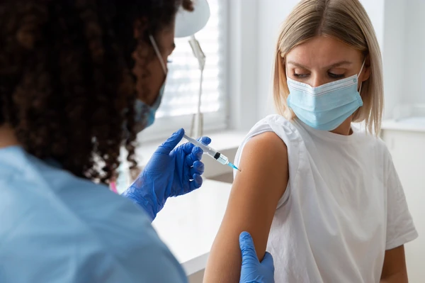 Clear Health Group nurse preparing vaccine at a workplace clinic