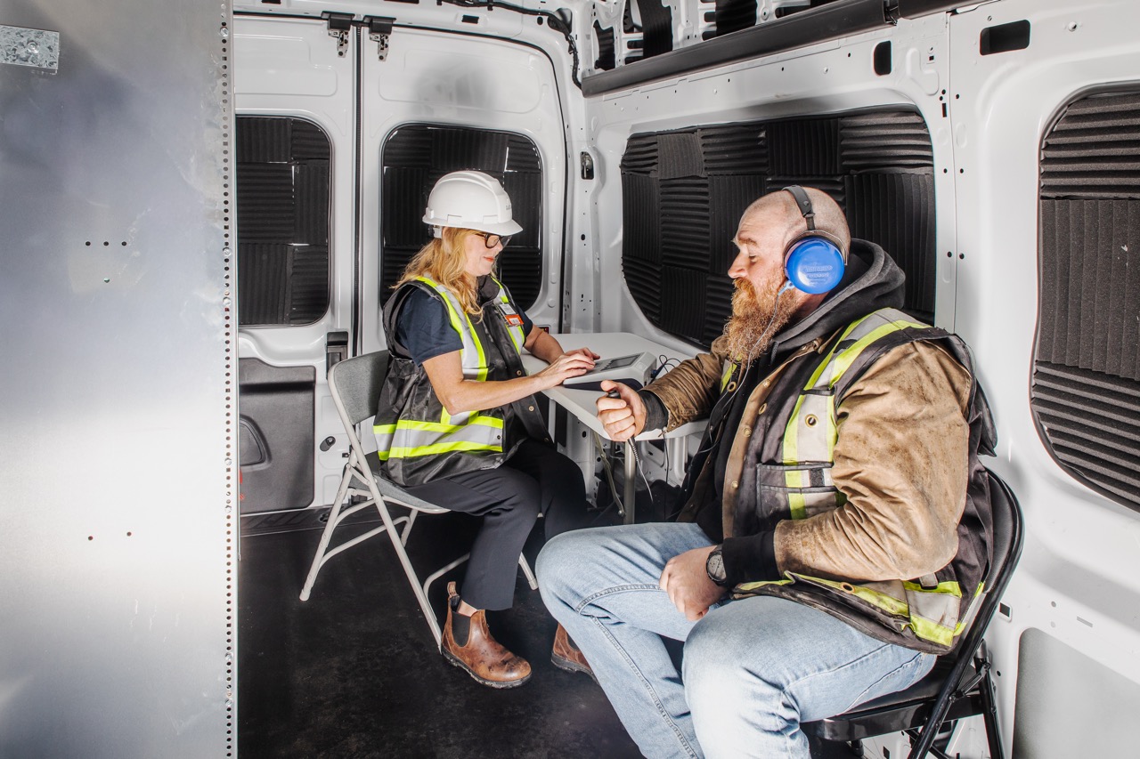 Clear Work hearing tester recording results on a tablet during an on-site audiometric test