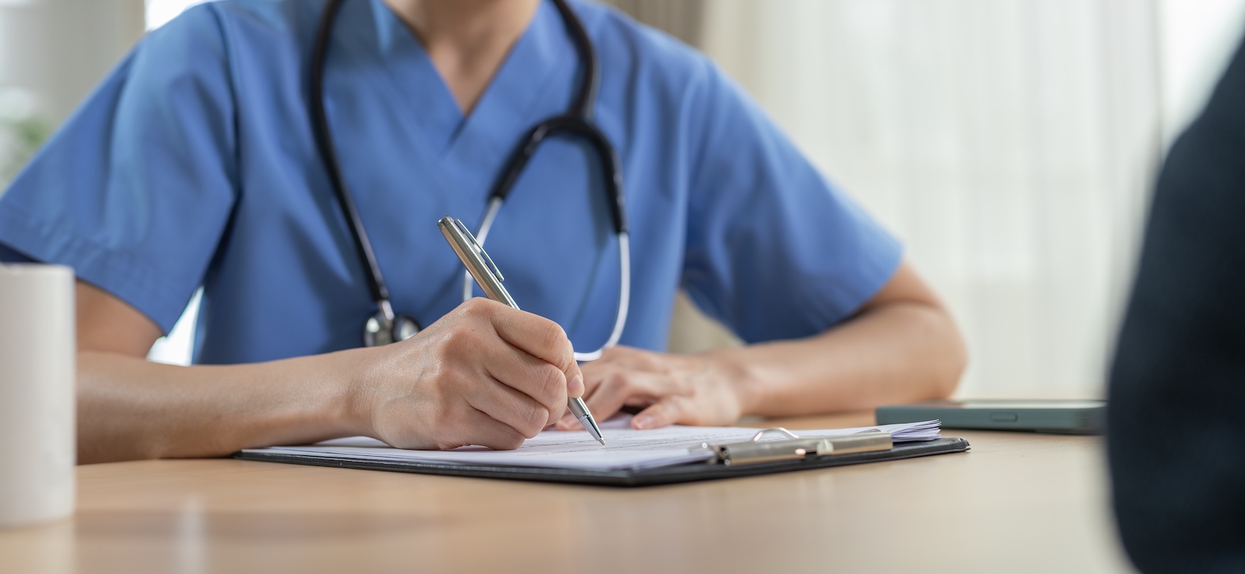 Clinician recording results on a clipboard during an on-site health assessment