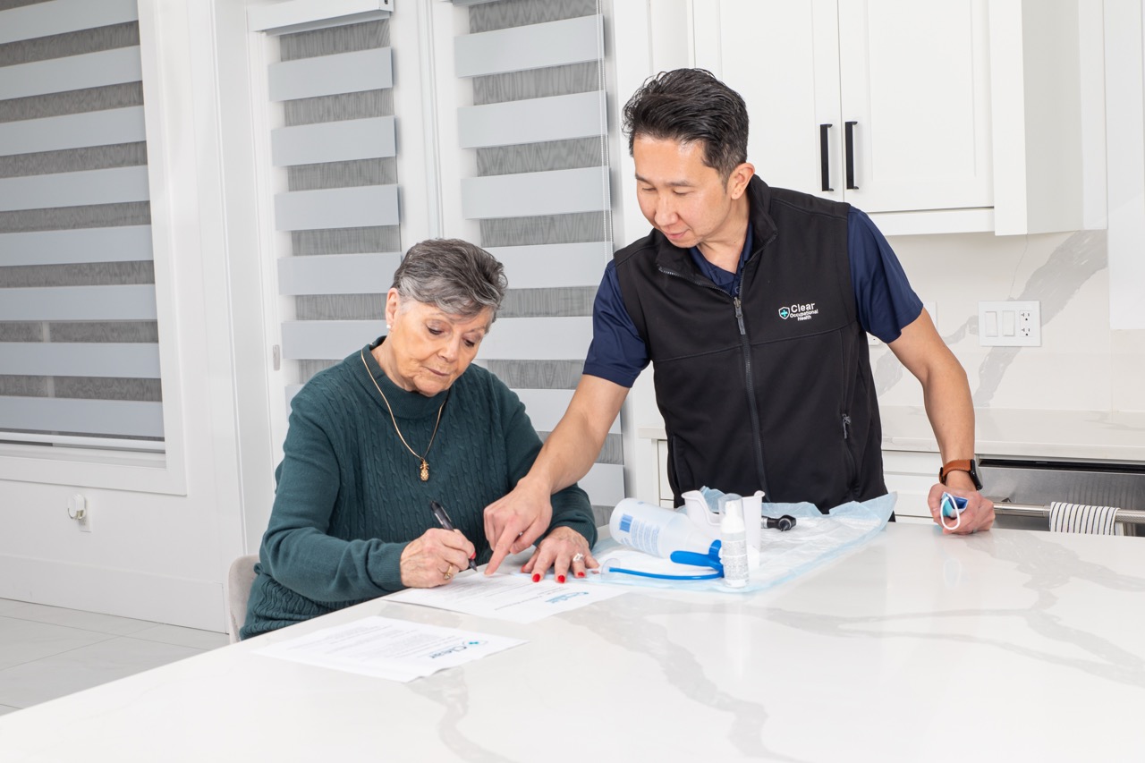 Nurse going through the written visit summary with a senior client