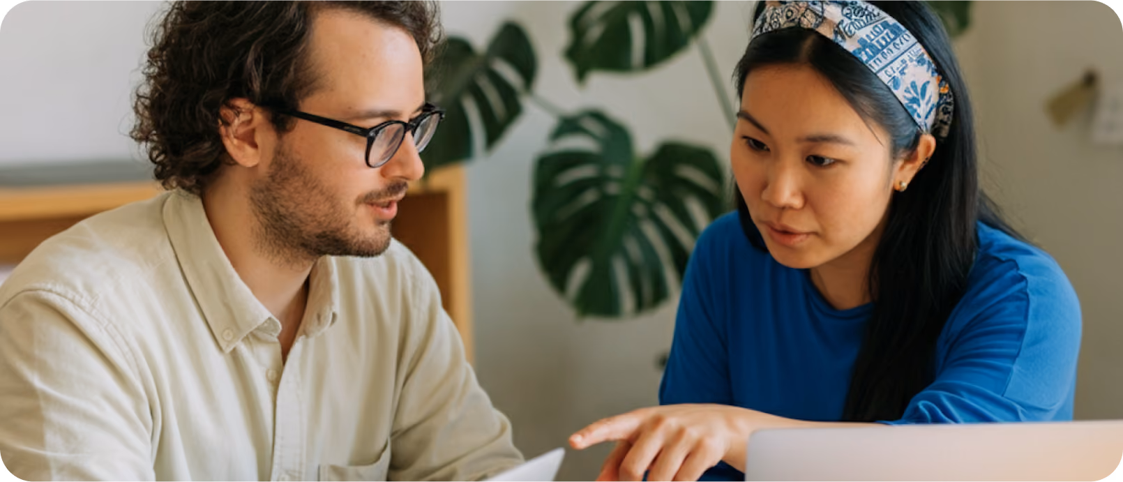 Two colleagues working together at a laptop