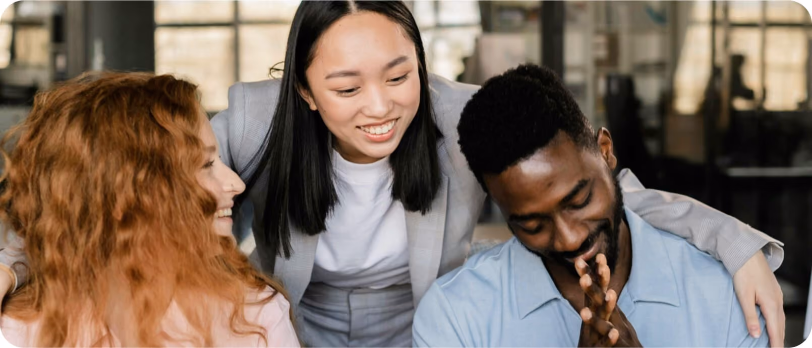 Three colleagues laughing together