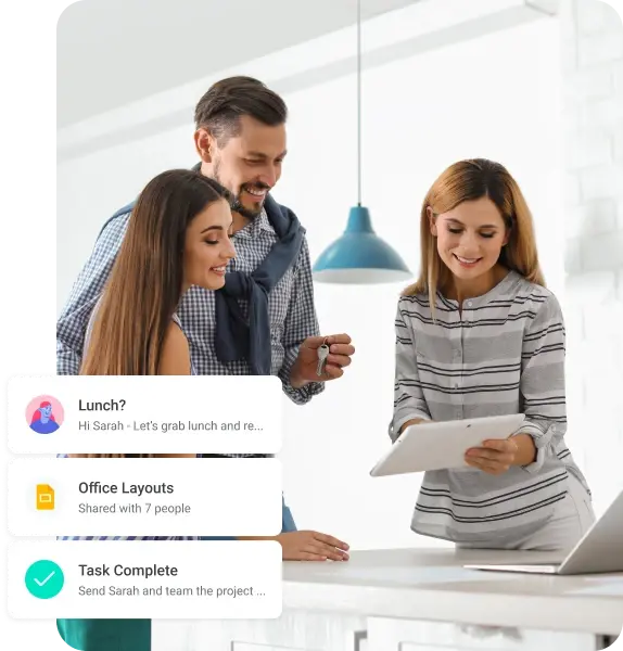 Real estate professionals reviewing a tablet together with Copper activity notifications