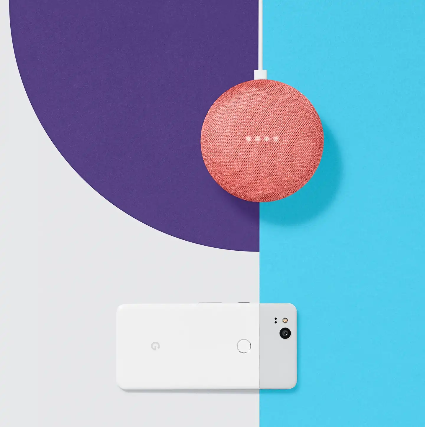 A coral Google Home Mini smart speaker and a white Google Pixel phone