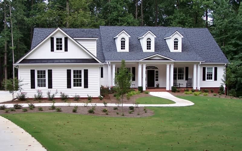 Owner May Anderson overseeing a roofing project in Virginia Beach, verifying VCC code compliance.