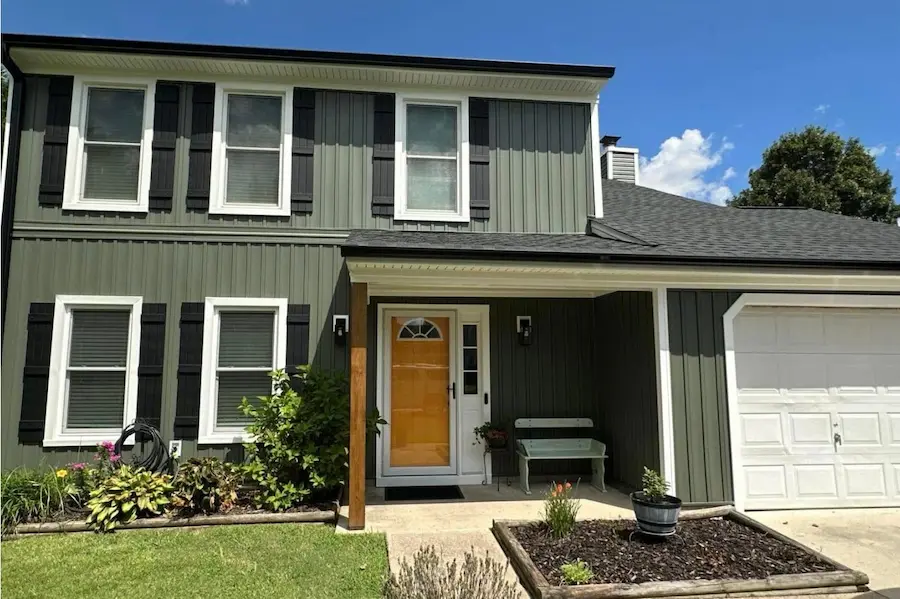 Owner May Anderson overseeing a roofing project in Virginia Beach, verifying VCC code compliance.