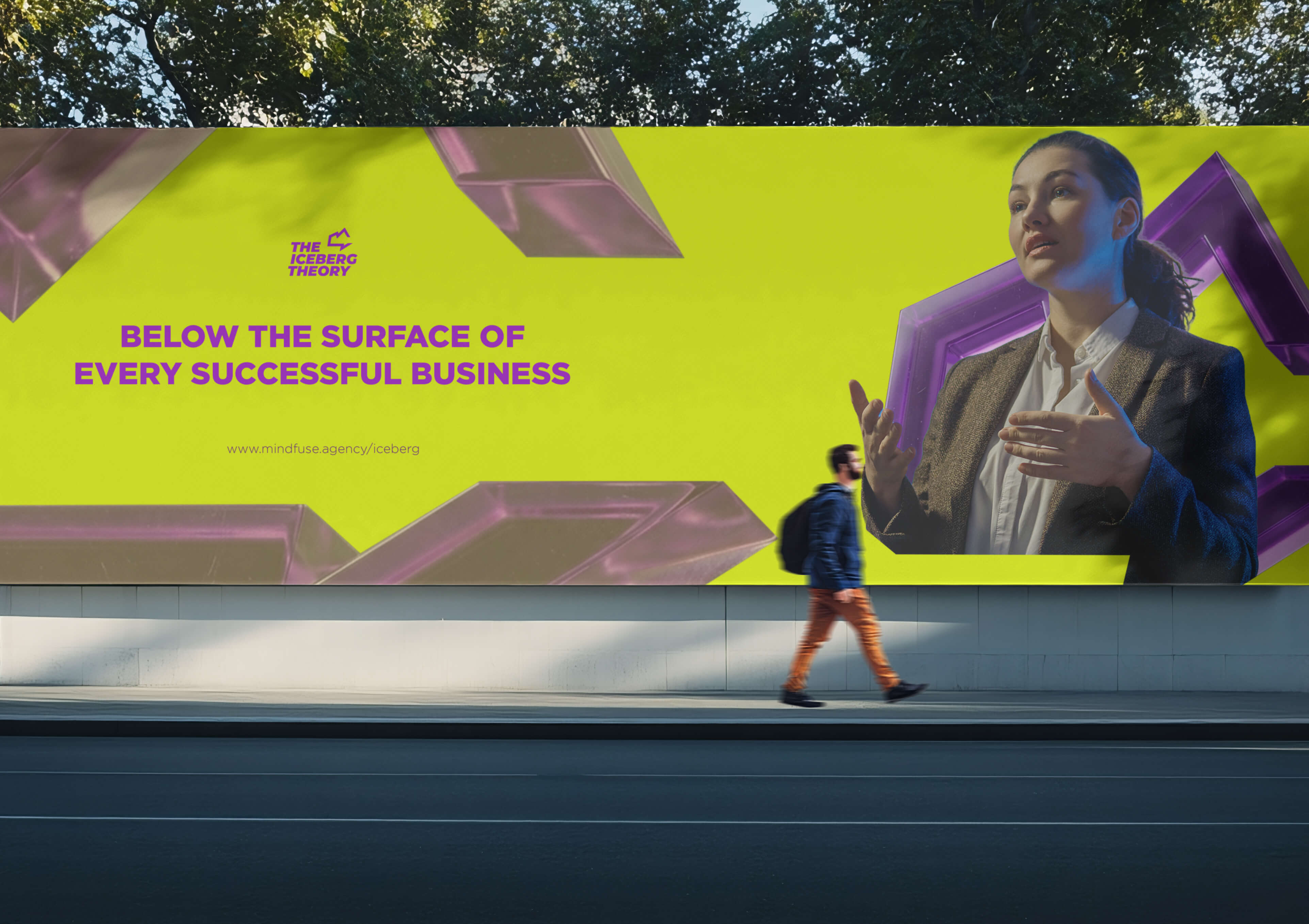 Billboard with the text 'Below the surface of every successful business' and image of a woman gesturing, while a man walks past on the sidewalk.