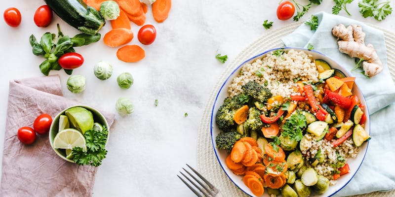 Flat-lay photography of Mediterranean salad with vegetables, grains, and herbs