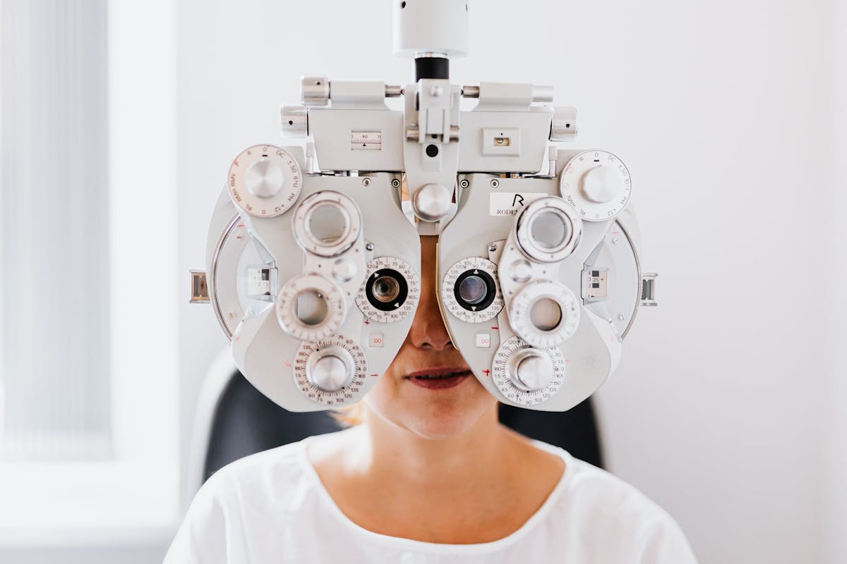 A person in a white shirt having an eye examination at a doctor's office